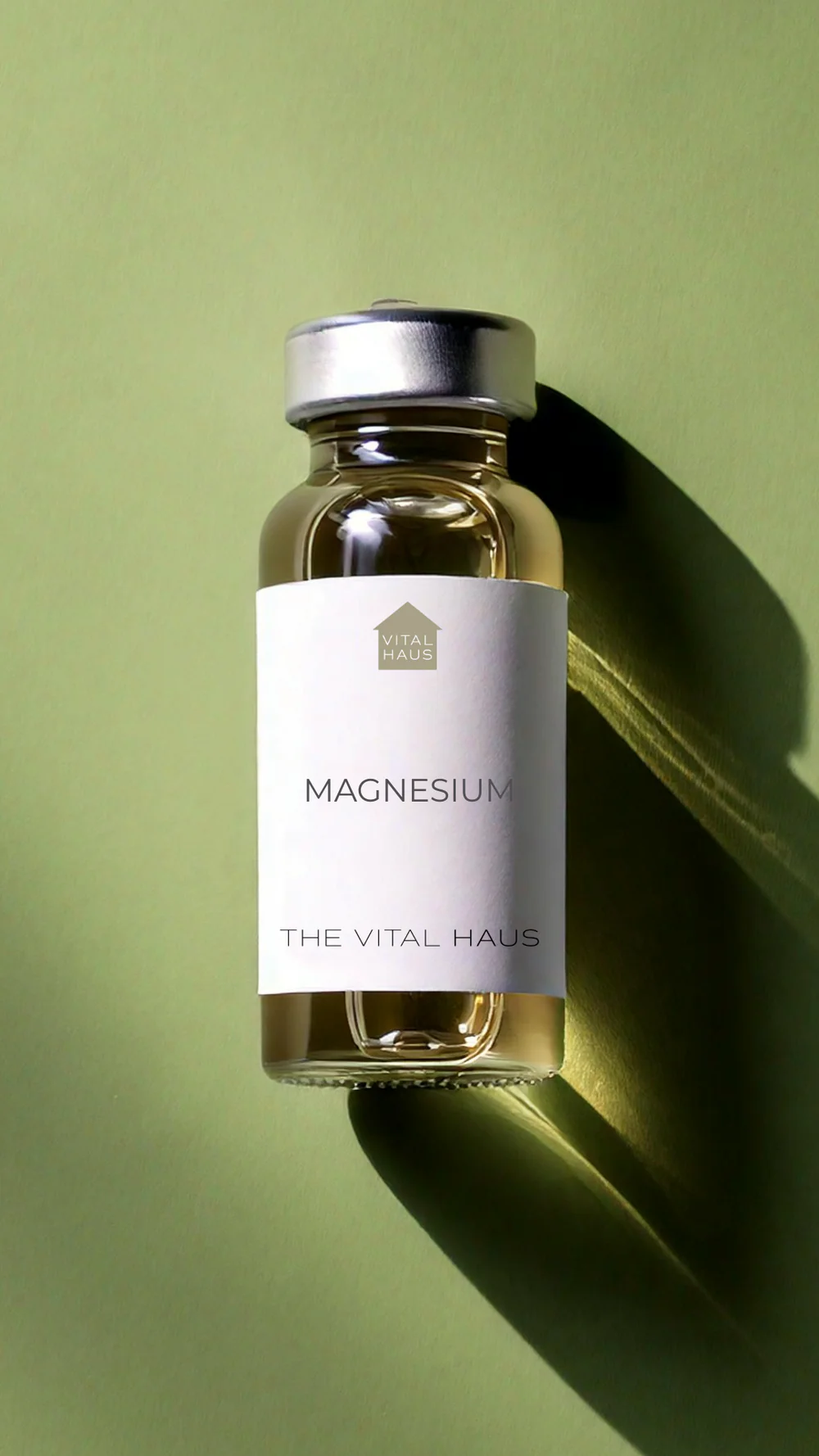 The image shows a bottle of magnesium supplements with a label on a shelf against a green background.