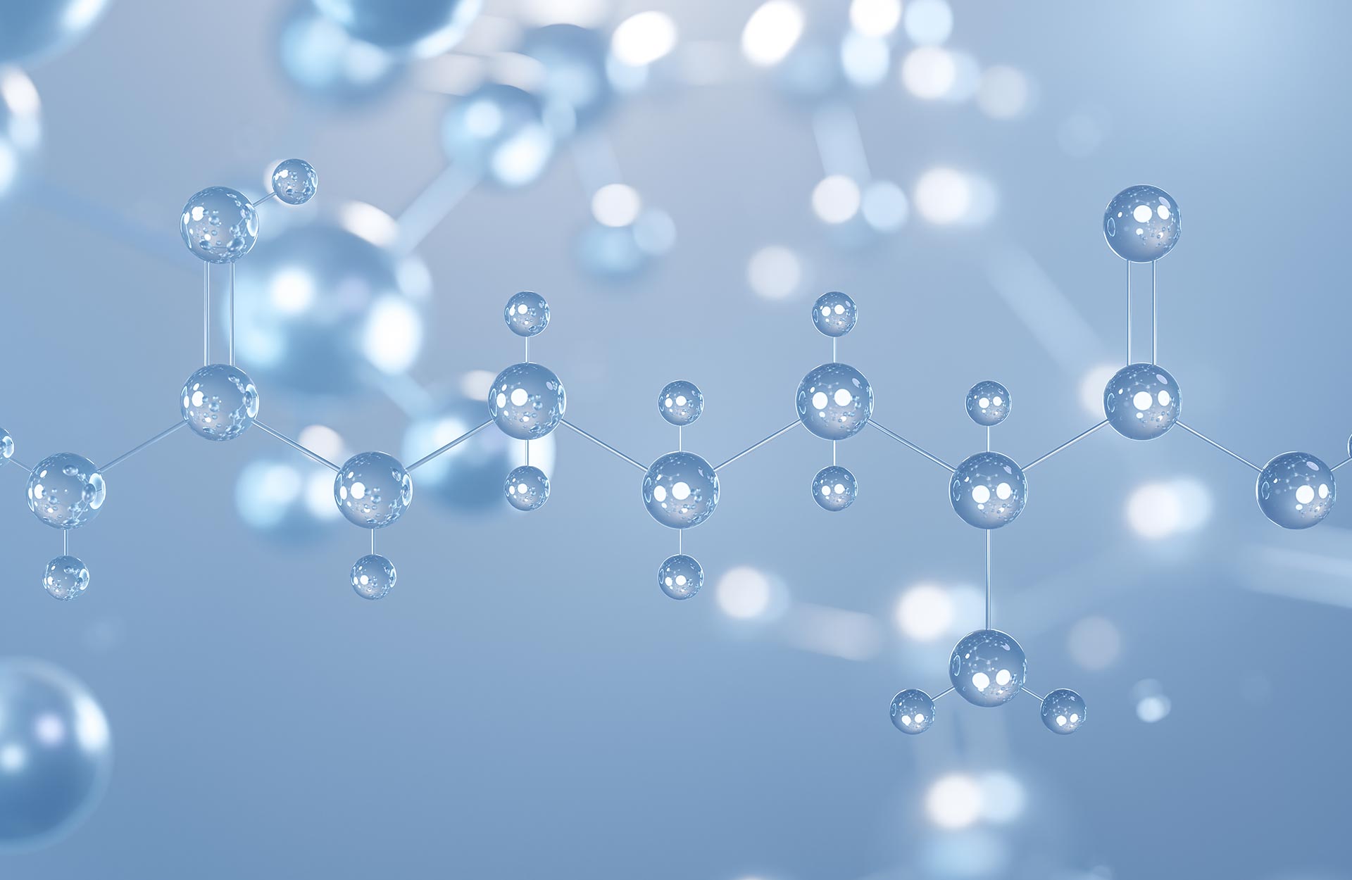 The image displays a microscopic view of spherical molecules arranged in a linear fashion, with a background that suggests a blue, crystalline substance, possibly representing a molecular structure or chemical compound.
